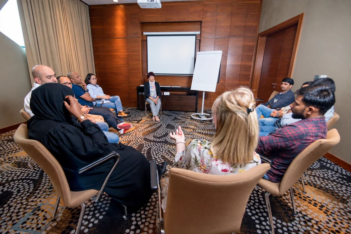 Colleagues sharing perspectives in a seated workshop